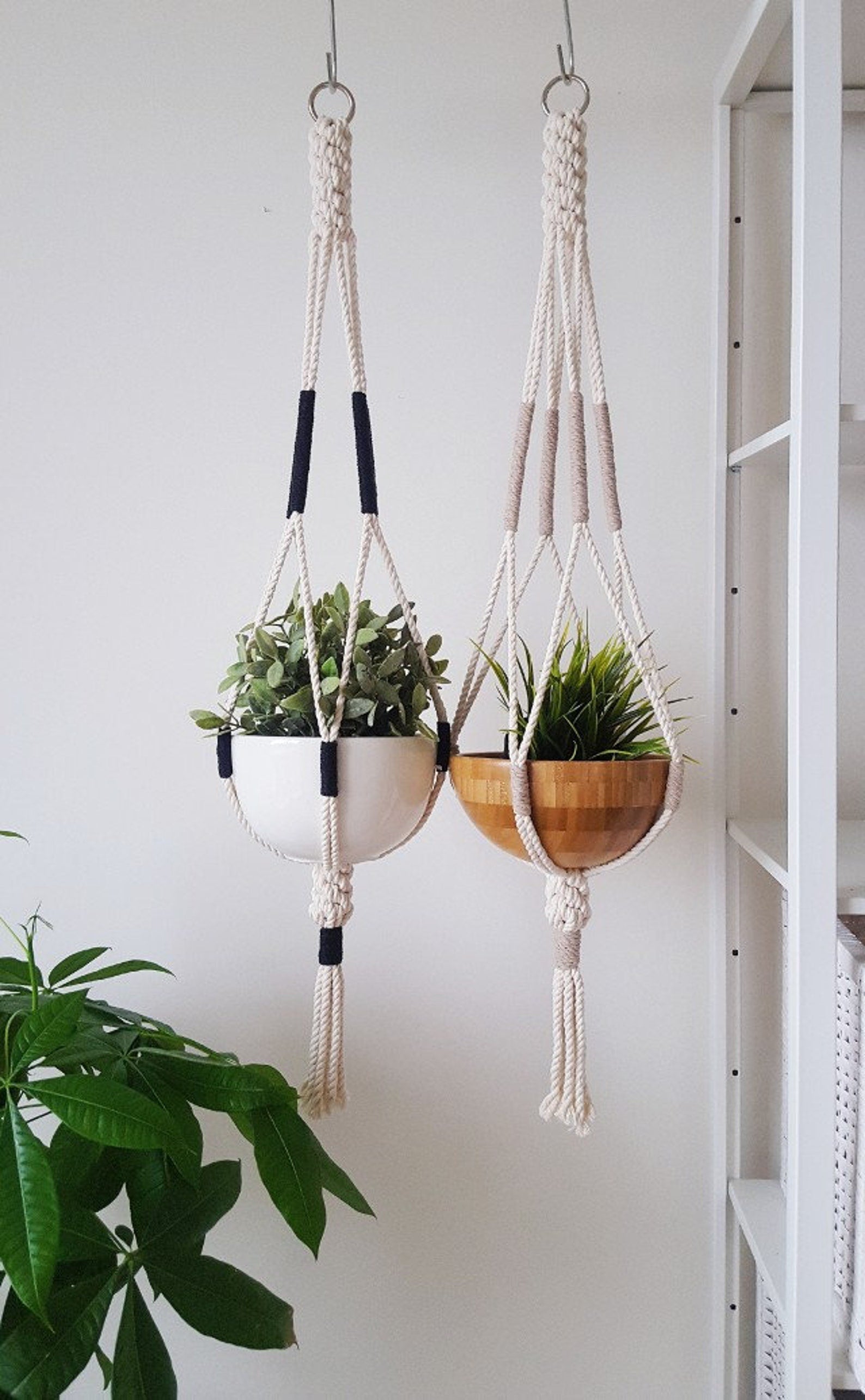 Two hanging planters with plants against a white wall made by Freefille