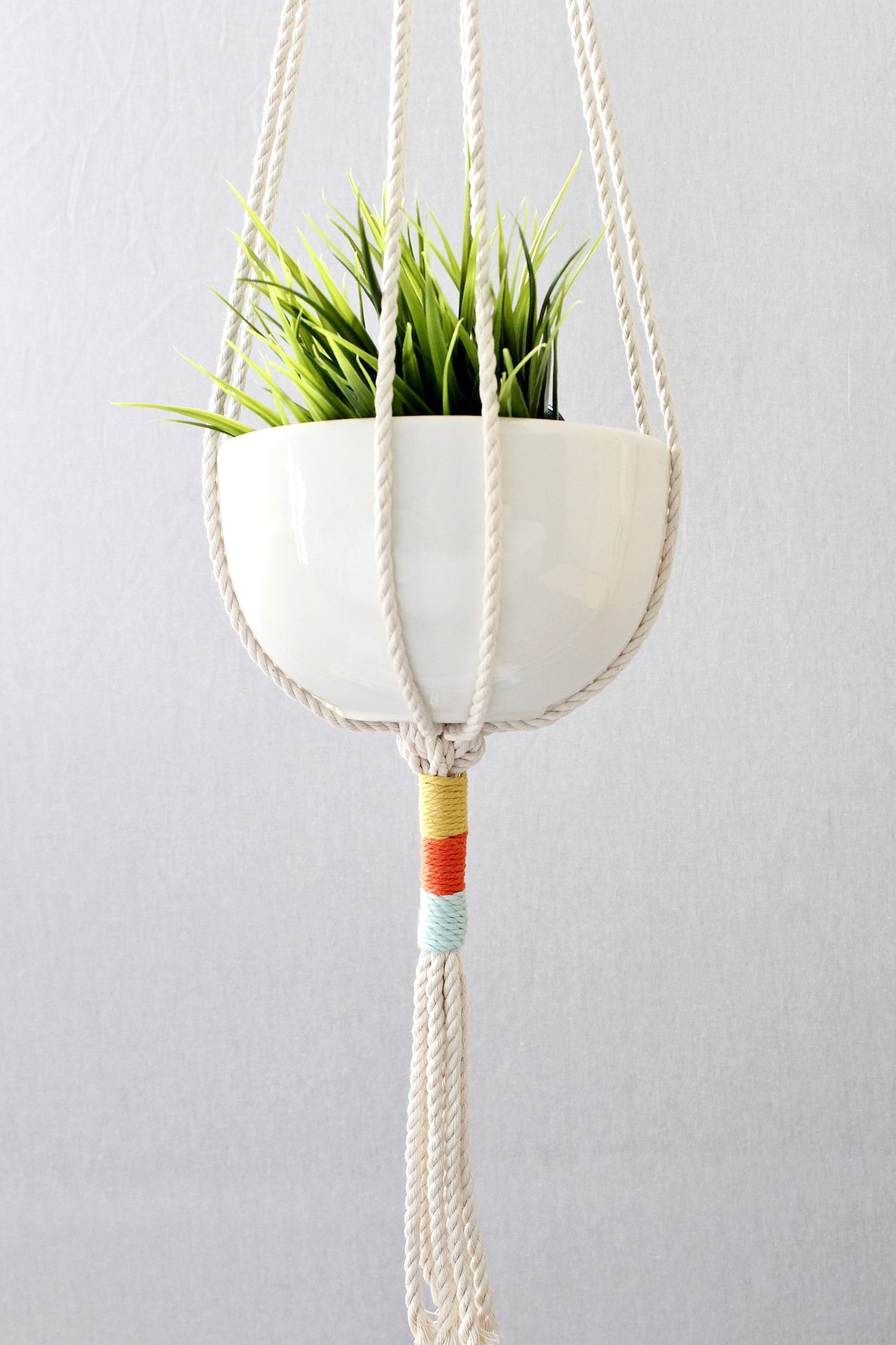 Macrame plant hanger with multi-colored wrapped accents, boho chic hanging planter, handmade cream cotton rope home decor made by Freefille