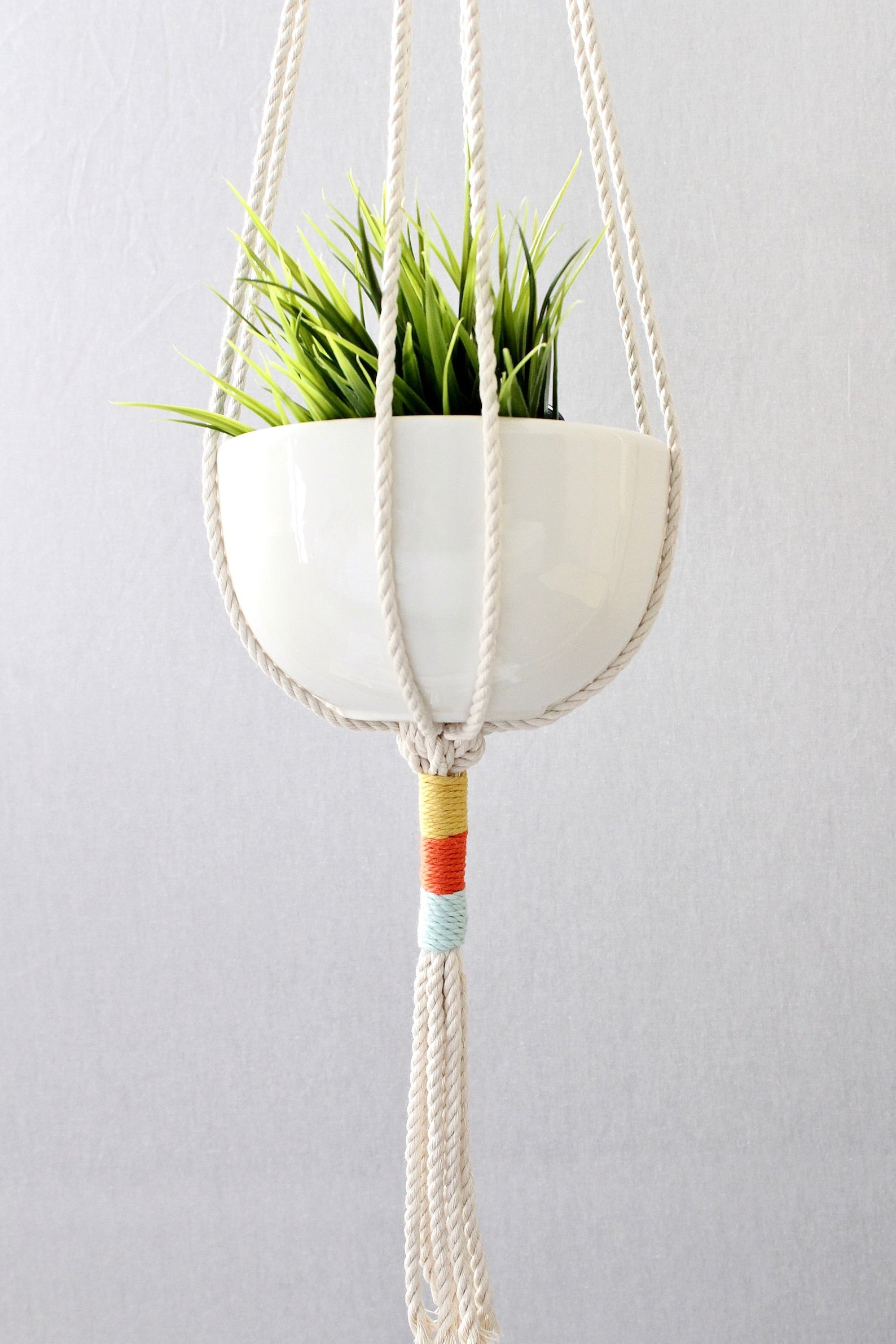 Macrame plant hanger with multi-colored wrapped accents, boho chic hanging planter, handmade cream cotton rope home decor made by Freefille