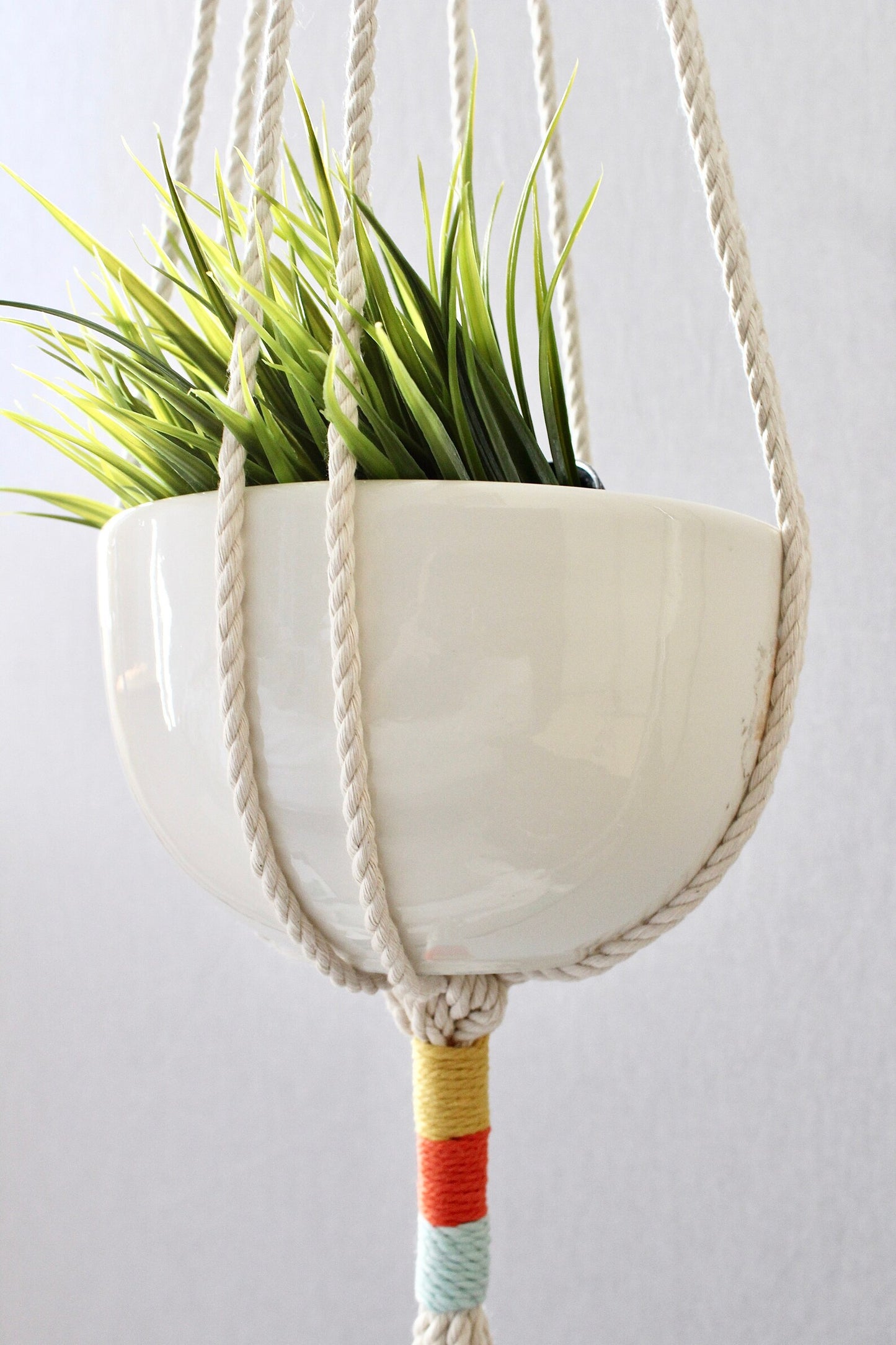 Macrame plant hanger with multi-colored wrapped accents, boho chic hanging planter, handmade cream cotton rope home decor made by Freefille