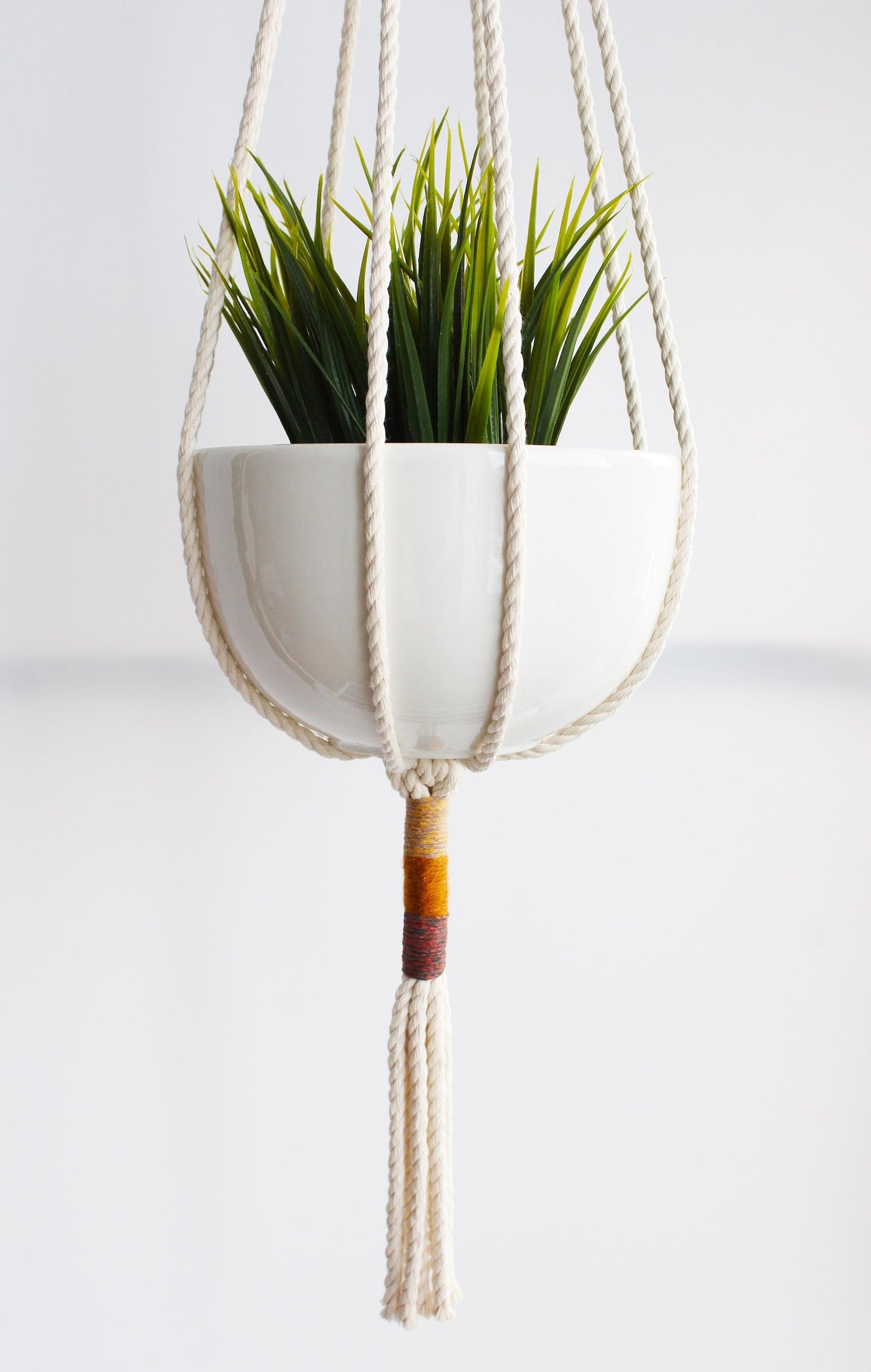 Macrame plant hanger with multi-colored wrapped accents, boho chic hanging planter, handmade cream cotton rope home decor made by Freefille