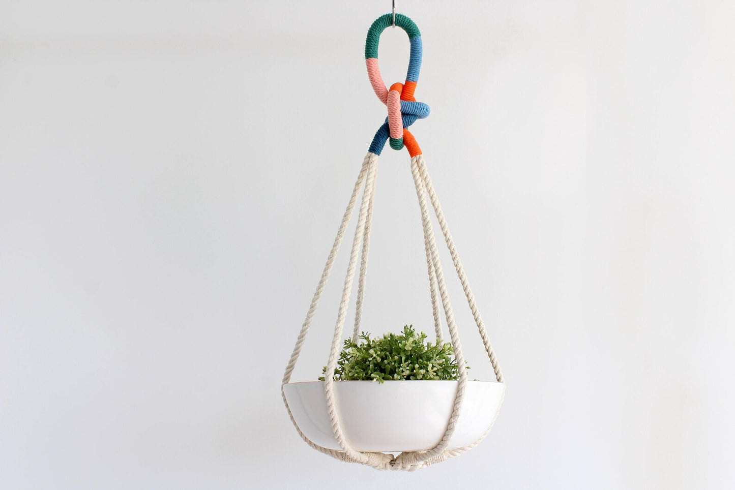 Tassel-free macrame plant hanger with colorful wrapped top loop knot holding a white ceramic bowl by Freefille